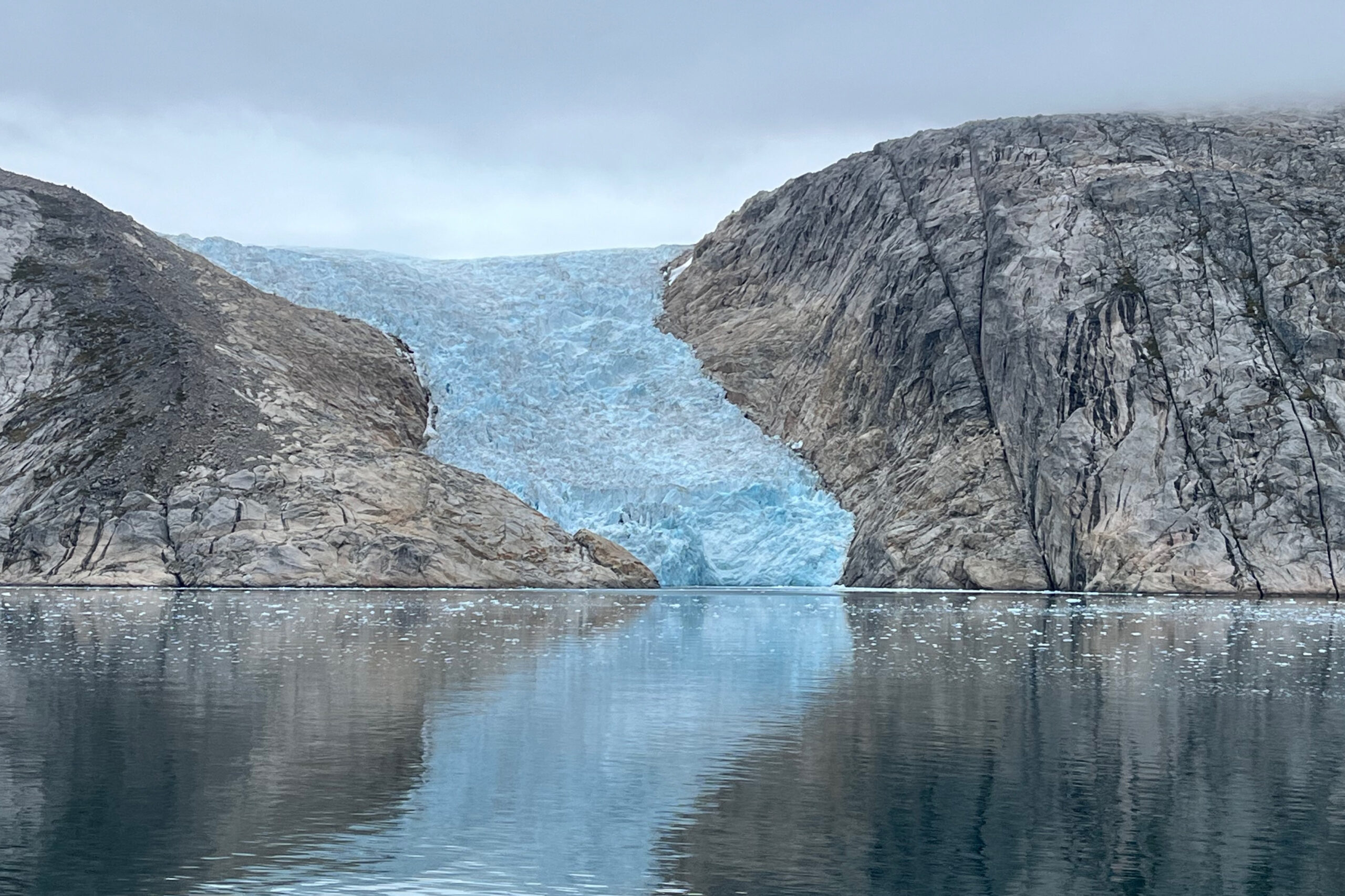 Microscopic Ice Defects Impact Glacier Flow Dynamics